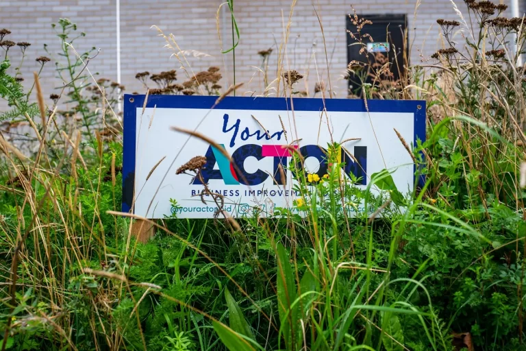 Your Acton BID sign photographed in nature